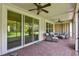 Covered brick patio with ceiling fans and comfortable outdoor seating, perfect for relaxation at 582 San Joaquin Rd, Poinciana, FL 34759