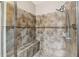 Beautiful shower with tiled walls, built-in seat, and upgraded shower head at 582 San Joaquin Rd, Poinciana, FL 34759