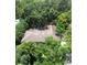 Aerial view of a home with a large roof surrounded by dense, mature trees at 860 Oak Shore Dr, St Cloud, FL 34771