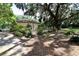 View of the backyard showing the well-maintained landscaping and shade trees at 860 Oak Shore Dr, St Cloud, FL 34771
