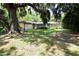 Backyard showcasing lawn, mature trees and the exterior of the home at 860 Oak Shore Dr, St Cloud, FL 34771