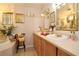Elegant bathroom with a soaking tub, double vanities, and decorative accents at 860 Oak Shore Dr, St Cloud, FL 34771