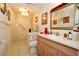 Bright bathroom featuring walk-in shower, tiled floor, and wooden vanity at 860 Oak Shore Dr, St Cloud, FL 34771