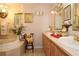 Elegant bathroom with a soaking tub, double vanities, and decorative accents at 860 Oak Shore Dr, St Cloud, FL 34771