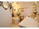 Elegant bathroom with a soaking tub, double vanities, and decorative accents at 860 Oak Shore Dr, St Cloud, FL 34771