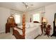 Cozy bedroom featuring a four-poster bed, traditional furnishings, and soft lighting at 860 Oak Shore Dr, St Cloud, FL 34771