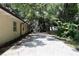 Long paved driveway leading to the home with a detached garage and wooded views at 860 Oak Shore Dr, St Cloud, FL 34771