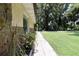 Exterior of home featuring stone accents along the side, a walkway, and lush green grass at 860 Oak Shore Dr, St Cloud, FL 34771