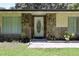 Front entrance with decorative stone features and lush landscaping at 860 Oak Shore Dr, St Cloud, FL 34771