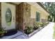 Charming front door with decorative glass, stone accents, and lush landscaping at 860 Oak Shore Dr, St Cloud, FL 34771