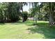 Expansive green front yard with mature trees offering shade and curb appeal for this beautiful single-story home at 860 Oak Shore Dr, St Cloud, FL 34771