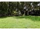 Expansive lawn with mature trees framing a charming single-story home in a serene setting at 860 Oak Shore Dr, St Cloud, FL 34771