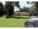 Traditional home boasts a well-maintained lawn and an asphalt driveway at 860 Oak Shore Dr, St Cloud, FL 34771