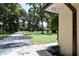 Front exterior view of home featuring long driveway, mature trees, and well-maintained lawn at 860 Oak Shore Dr, St Cloud, FL 34771