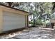 View of detached garage with chain-link fence and gate at 860 Oak Shore Dr, St Cloud, FL 34771