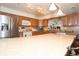 Open concept kitchen with wood cabinets, stainless steel refrigerator, an island with bar seating, and lots of light at 860 Oak Shore Dr, St Cloud, FL 34771