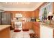 Bright kitchen features oak cabinets, an island counter with bar seating, and stainless steel appliances at 860 Oak Shore Dr, St Cloud, FL 34771