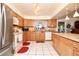 Kitchen showcasing natural wood cabinets, a stainless steel refrigerator, and an island counter with a breakfast bar at 860 Oak Shore Dr, St Cloud, FL 34771