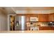 Kitchen boasting wood cabinets, stainless steel refrigerator, and an island counter with chairs at 860 Oak Shore Dr, St Cloud, FL 34771