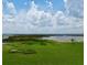 Scenic view of a sprawling lake with lush greenery under a partly cloudy sky at 860 Oak Shore Dr, St Cloud, FL 34771