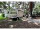 Exterior of a shed with a roll-up door on a wooded lot at 860 Oak Shore Dr, St Cloud, FL 34771