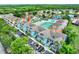 Bright and airy condo community featuring a pool, tennis courts, parking, and mature trees at 8716 Rain Forest Pl # D, Kissimmee, FL 34747