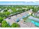 Overhead view of blue condo complex with mature trees and well-maintained tennis court at 8716 Rain Forest Pl # D, Kissimmee, FL 34747