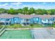 Scenic aerial view of blue condo buildings featuring private balconies overlooking a tennis court at 8716 Rain Forest Pl # D, Kissimmee, FL 34747
