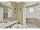 Bright bathroom with tiled shower, updated vanity, and decorative accents at 8716 Rain Forest Pl # D, Kissimmee, FL 34747