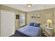 Cozy bedroom with natural light, closet, and a comfortable bed with blue bedding at 8716 Rain Forest Pl # D, Kissimmee, FL 34747