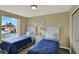 Charming bedroom featuring twin beds with matching headboards and a community view at 8716 Rain Forest Pl # D, Kissimmee, FL 34747