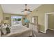 Spacious main bedroom with a ceiling fan, deck access, and a dresser at 8716 Rain Forest Pl # D, Kissimmee, FL 34747