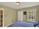 Cozy bedroom with neutral walls, window, and closet perfect for a relaxing retreat at 8716 Rain Forest Pl # D, Kissimmee, FL 34747