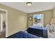 Comfortable bedroom with twin beds, neutral walls, and a window with lots of light at 8716 Rain Forest Pl # D, Kissimmee, FL 34747