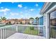 Deck view showcasing community buildings and a tennis court for recreational enjoyment at 8716 Rain Forest Pl # D, Kissimmee, FL 34747