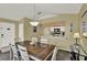 Well-lit dining room featuring neutral paint, a wooden table with seating for six, and access to the kitchen at 8716 Rain Forest Pl # D, Kissimmee, FL 34747