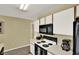 Neat kitchen with modern appliances, white cabinets, and laminate countertops at 8716 Rain Forest Pl # D, Kissimmee, FL 34747