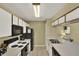 Well-maintained kitchen with white cabinets, black appliances, and laminate countertops at 8716 Rain Forest Pl # D, Kissimmee, FL 34747