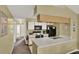 Bright kitchen with white cabinets, black appliances, and convenient breakfast bar at 8716 Rain Forest Pl # D, Kissimmee, FL 34747