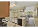 Open kitchen view of dining and living area, creating an inclusive and inviting space at 8716 Rain Forest Pl # D, Kissimmee, FL 34747