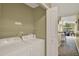 A conveniently located laundry area with washer, dryer and shelving for storage at 8716 Rain Forest Pl # D, Kissimmee, FL 34747
