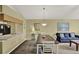 Neutral interior features a kitchen view, living and dining area with carpeted floor and neutral paint at 8716 Rain Forest Pl # D, Kissimmee, FL 34747