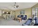 Comfortable living room and dining area with ceiling fan and large painting on the wall at 8716 Rain Forest Pl # D, Kissimmee, FL 34747