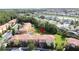 Aerial view of colorful townhomes with red roofs, lush trees, and a green common area at 109 Pompano Beach Dr, Kissimmee, FL 34746