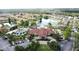 Aerial view of community clubhouse with a pool, playground, lake, and mature landscaping at 109 Pompano Beach Dr, Kissimmee, FL 34746