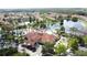 Aerial view of a clubhouse with a pool, miniature golf, playground, and scenic lake at 109 Pompano Beach Dr, Kissimmee, FL 34746