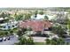 Community clubhouse with a porte cochere, lush landscaping, palm trees, and ample parking at 109 Pompano Beach Dr, Kissimmee, FL 34746