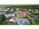 Community clubhouse with a pool, basketball court, playground, and ample parking nestled among the trees at 109 Pompano Beach Dr, Kissimmee, FL 34746