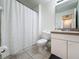 Full bathroom with shower curtain, toilet and vanity with ample storage at 109 Pompano Beach Dr, Kissimmee, FL 34746
