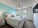 Well-lit bedroom with a ceiling fan, large window, and a comfortable king-sized bed at 109 Pompano Beach Dr, Kissimmee, FL 34746